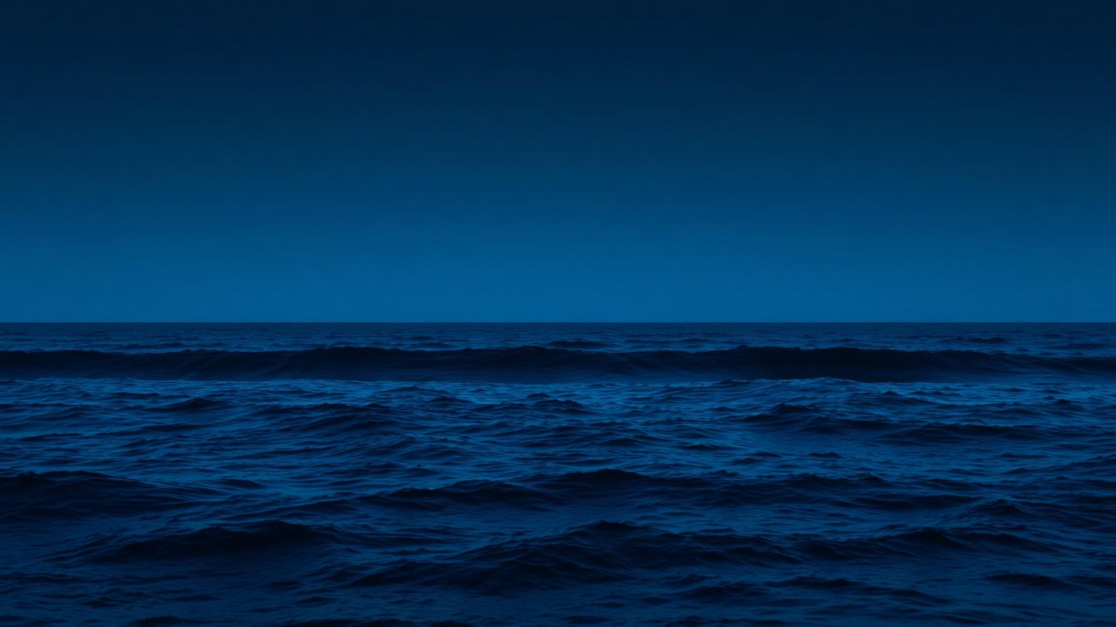 Deep blue ocean waves at dusk